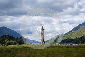 Glenfinnan Monument with Loch Shiel, during cloudy day,, near Glenfinnan Viaduct, in Scotland