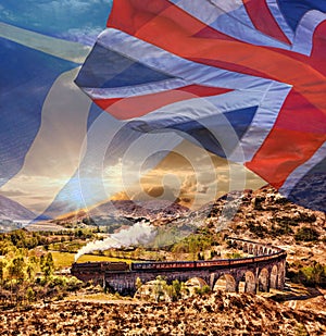 Glenfinnan Railway Viaduct in Scotland with the Jacobite steam train against scottish ang british flags