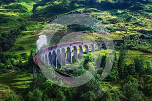 Glenfinnan Railway Viaduct in Scotland with a steam train photo