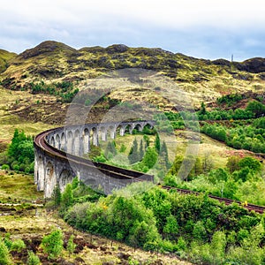 Glenfinnan Viaduct, Scotland. Travel tourist destination in Europe. Old historical steam train riding on film scene famous Harry