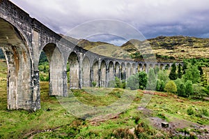 Glenfinnan Viaduct, Scotland. Travel tourist destination in Europe. Old historical steam train riding on film scene famous Harry