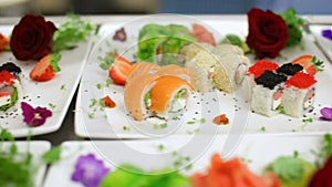 Glide camera panorama of delicious sushi beautifylly served with strawberry, salad and ginger as a side