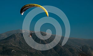 Glider on a background of mountains and sky