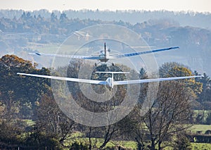 Glider being aero towed towards a ridge