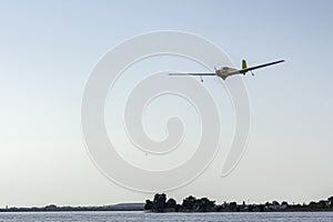 Glider flying upon the lake