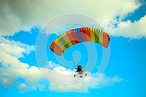 A glider flying under the blue sky