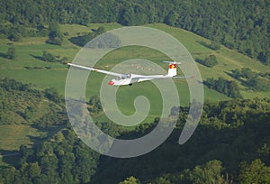 A glider Janus flying over Challes les eaux