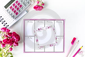Glider with notes and to-do list on a white background with pink stationery. Business concept