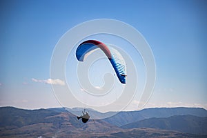 glider paragliding g against blue sky flying  adrenaline and freedom concept