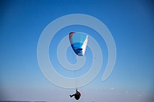 glider paragliding g against blue sky flying  adrenaline and freedom concept