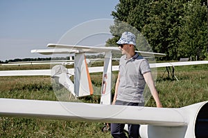 Glider pilot getting ready for flight on small motorless aircraft