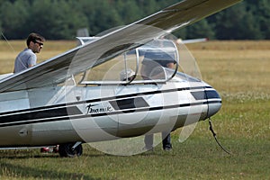 Glider plane standing on grass airport runway, at Pociunu airport, Lithuania