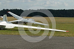 Glider plane standing on grass airport runway, at Pociunu airport, Lithuania