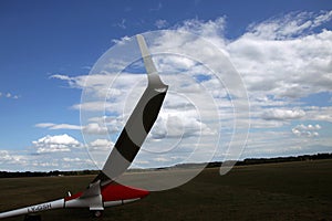 Glider plane standing on grass airport runway, at Pociunu airport, Lithuania