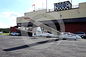 Glider plane standing on grass airport runway, at Pociunu airport, Lithuania