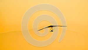 Glider silhouette flying at sunset