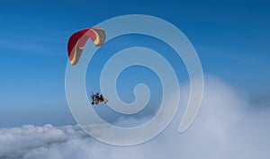 Gliding high over cloud in paramotor.