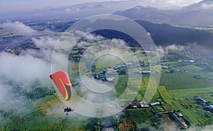 Gliding high over cloud in paramotor.