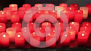 A glimmer of light. red candles in church