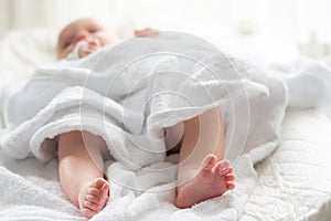 Glimpse of infancy's gentle moments. Concept of soft care after baby's first wash