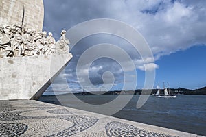 Glimpse of the monument to the discoveries and bridge 25 April on the river Tagus in Lisbon