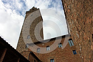 Glimpses of the romantic Tuscan town of San Gimignano in stones on the ancient hill