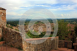 Glimpses of the romantic Tuscan town of San Gimignano in stones on the ancient hill