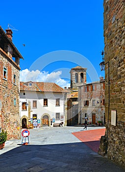 Glimpsy in old historic alley with castle stone tower in the medieval village of Anghiari near city of Arezzo in Tusca photo