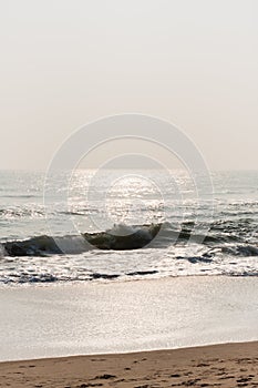Glistening waves on beach