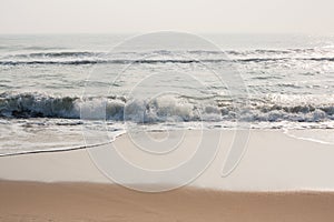 Glistening waves on beach