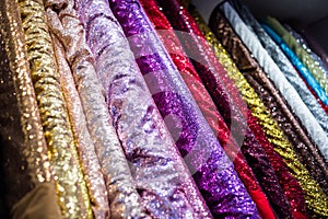 Glitter fabric rolls on display in a sewing store