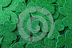 Glitter green clover leaves as background, top view. St. Patrick`s Day celebration