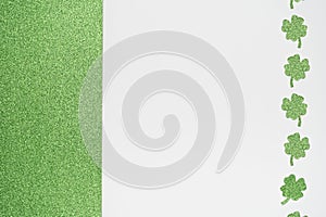 Glitter green and white background with sparkly clover shamrock