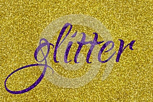 Glitter lettering word ultra violet on gold sparkle texture. Shiny background