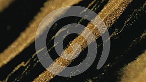 Glitter paint spill fluid background golden black