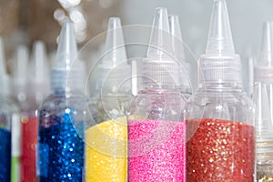 Glitter in plastic bottles. Decorative sequins to give shine