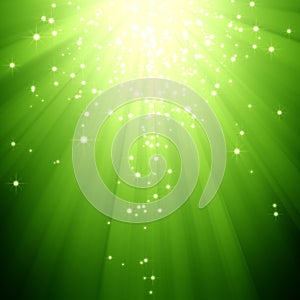 Glitter stars descending on green light burst