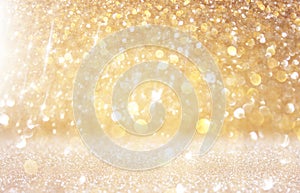 Glitter vintage lights background. light gold and black. defocused