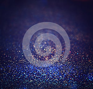 Glitter vintage lights background. light silver, purple, blue, gold and black. defocused.