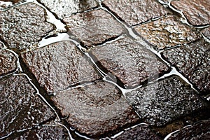 Glittering wet cobblestone after rain