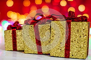 Glittery Christmas gifts. Christmas decorations on blurred lights background