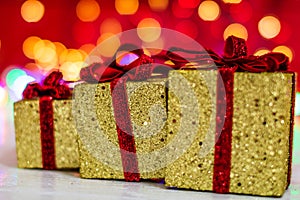 Glittery Christmas gifts. Christmas decorations on blurred lights background