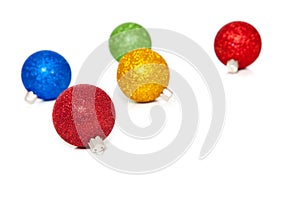 Glittery Christmas ornaments on white