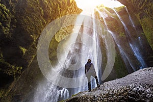 Gljufrabui waterfall in South Iceland,  adventurous traveller standing in front of the stream cascading into the gorge or canyon,