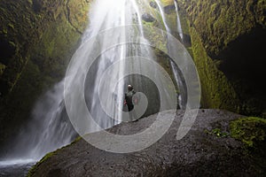 Gljufrafoss waterfall with active woman