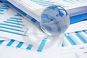 Global business concept. Glass globe and financial charts