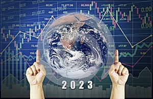 Global business forecast in 2023 show successful economy with fingers point up symbol on graph and chart for world financial
