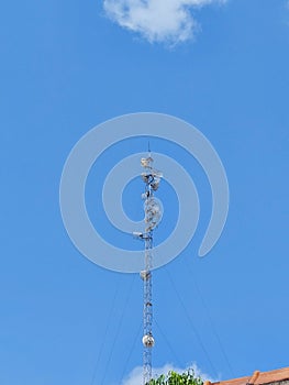 Global Communication Tower Against Blue Sky - Wireless Technology and Satellite Dish