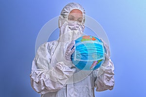 Global Coronavirus Pandemic. Globe of the World with a medical mask. A woman in a medical mask