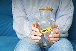 Global crisis and no money savings concept with empty glass jar labeled savings